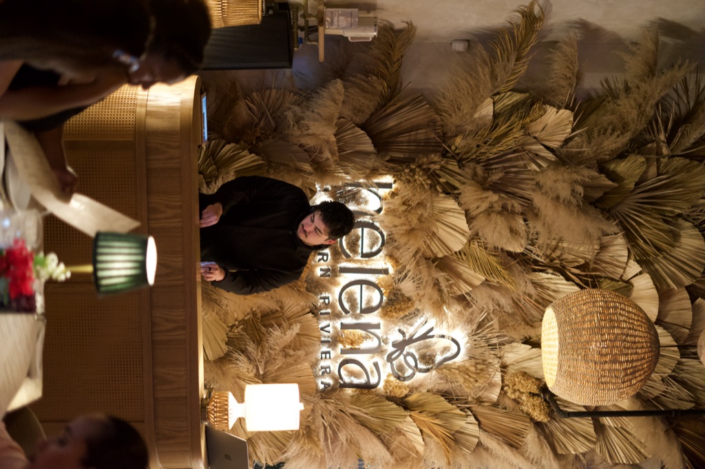 Wide shot of Helena Modern Riviera with DJ OTEO at the booth, pampas-grass installation